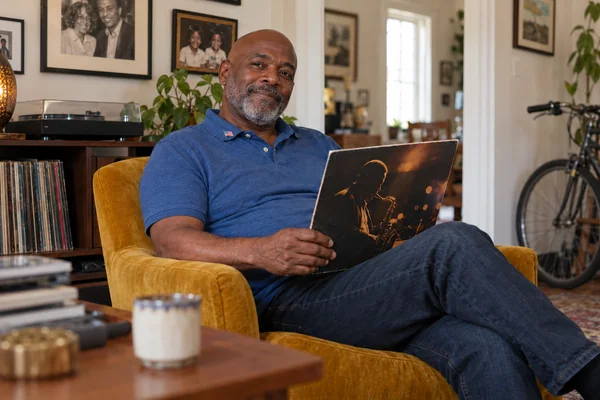 AI-created fictional Marcus Johnson, aged 63, in a personal veterans’ residential room. No real person or institution.